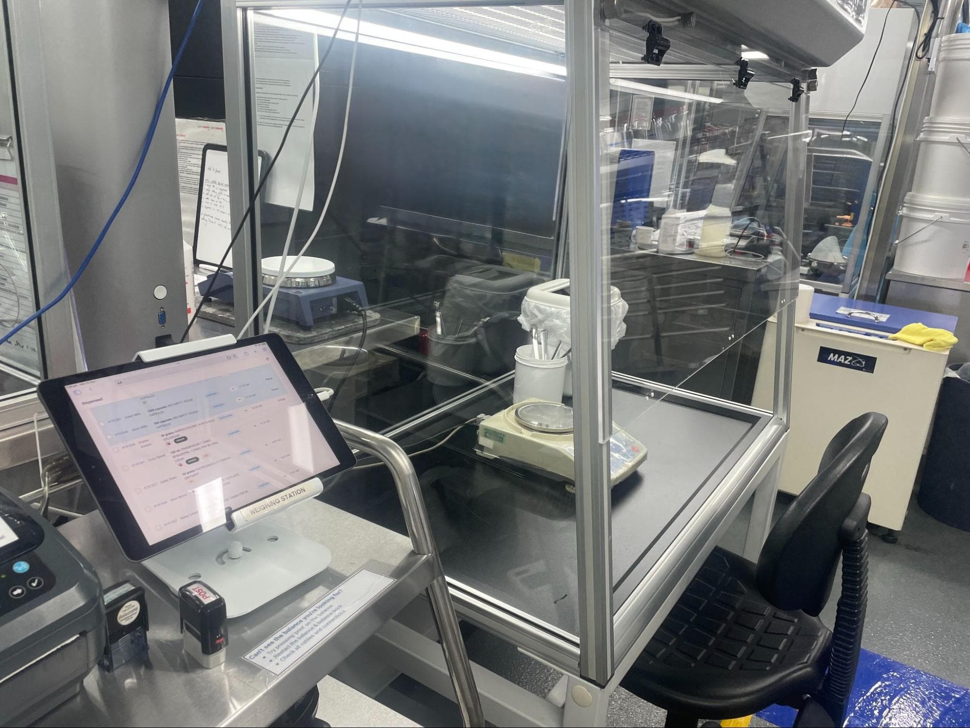 ipad with a weighing scale in a compounding laboratory