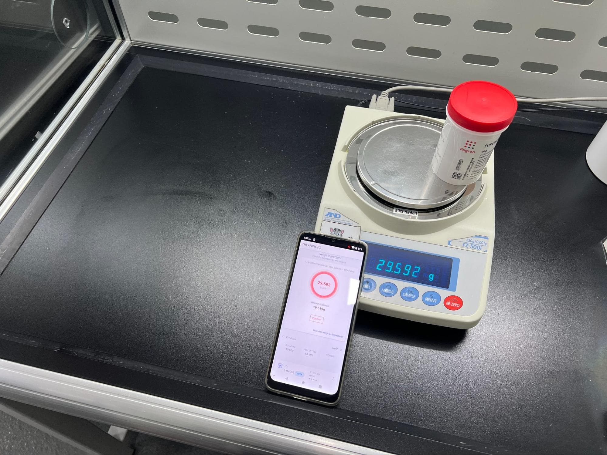 Android with weighing scale in a lab